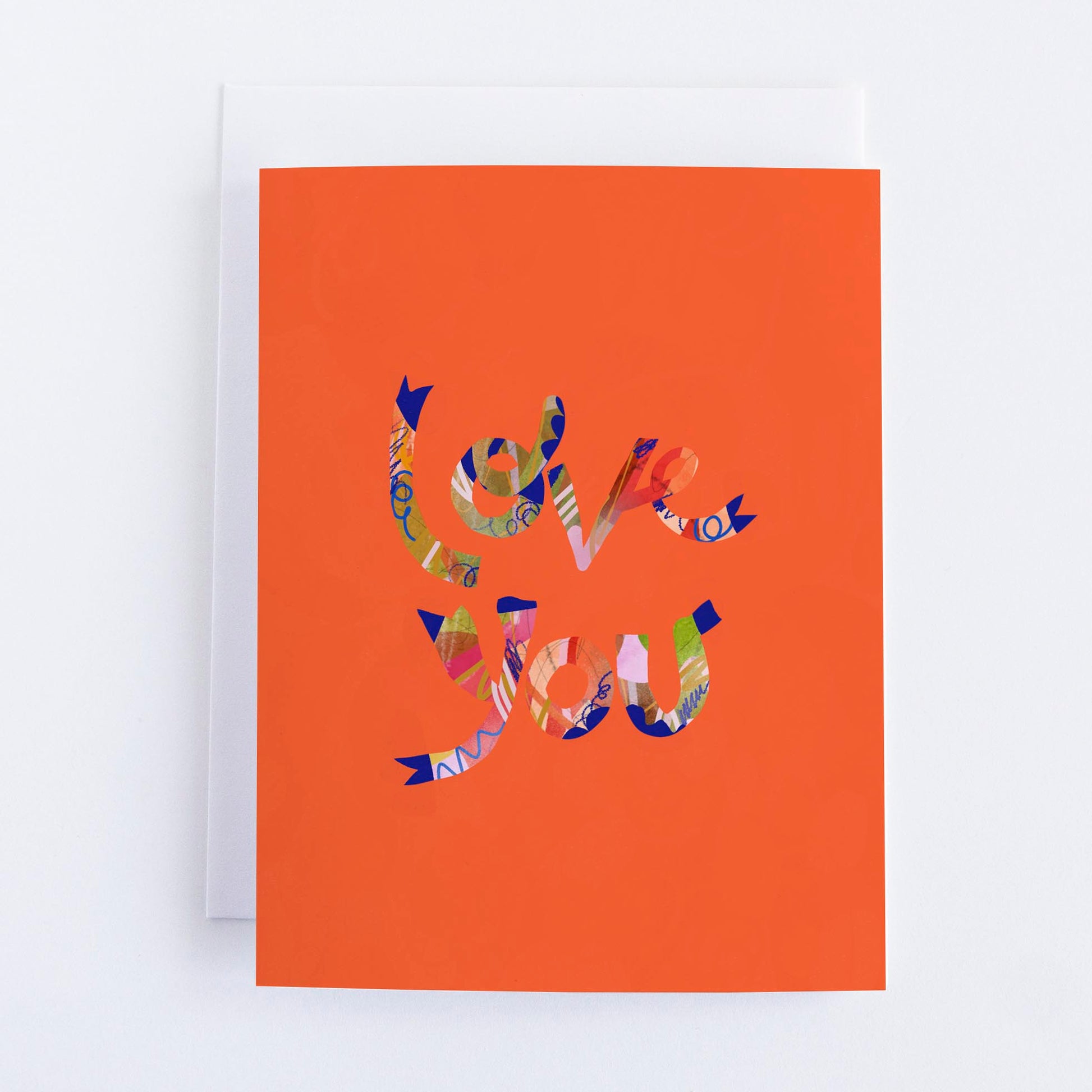 A vibrant orange greeting card with a colorful abstract heart design in the center, blank interior, and envelope included.