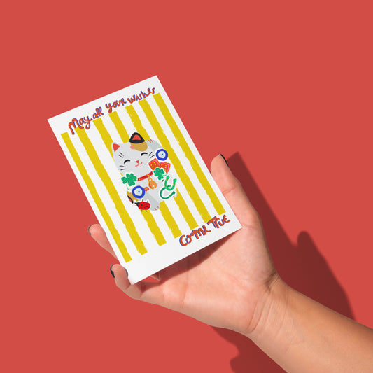 Hand holding a card with a cat illustration and text on a red background