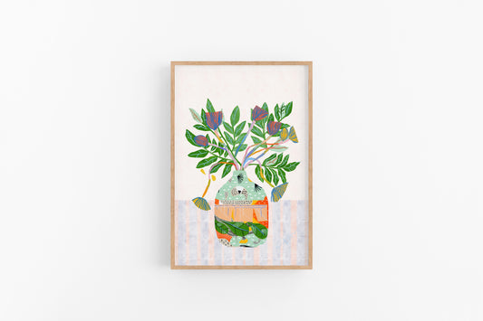 Framed artwork of a colorful vase with leaves on a white background