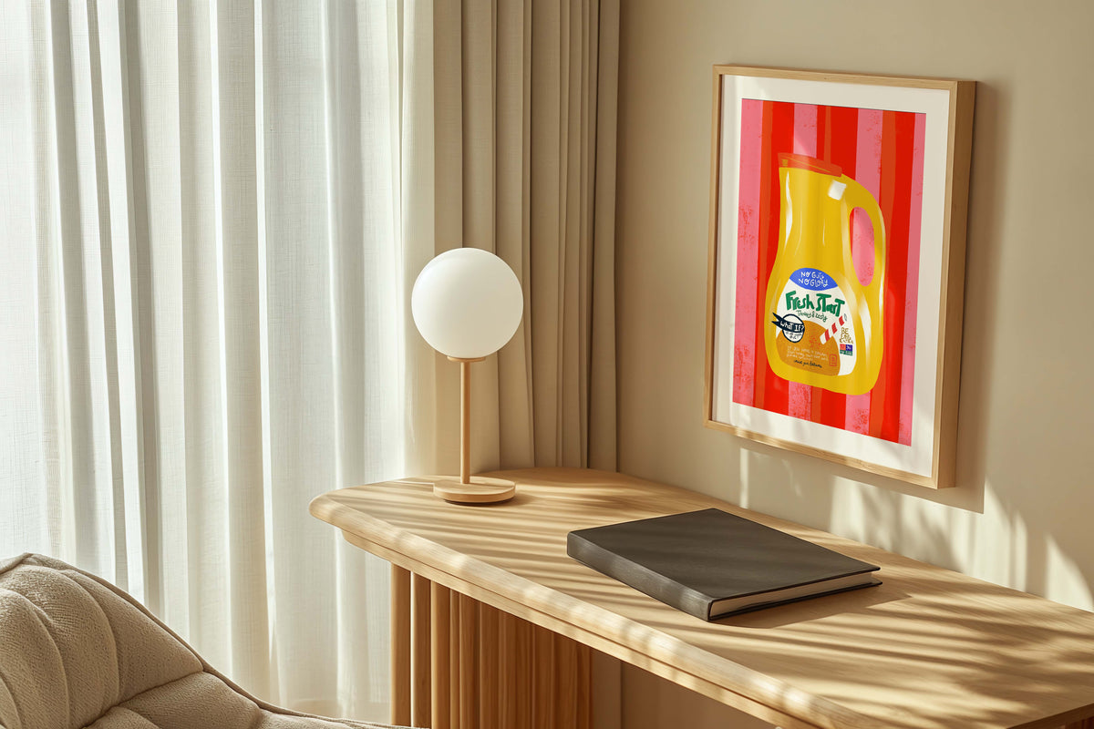 Modern interior with a wooden desk, lamp, and framed artwork on a beige wall.