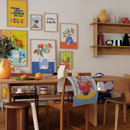 Vibrant art print of a Scrabble board, wine bottle, and blue candlesticks on an Italian dinner table. Bold yellow and blue maximalist wall decor.