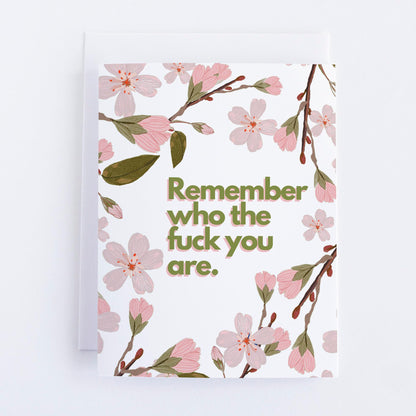 A greeting card with a floral design and the text 'Remember who the f*** you are' printed in the center.